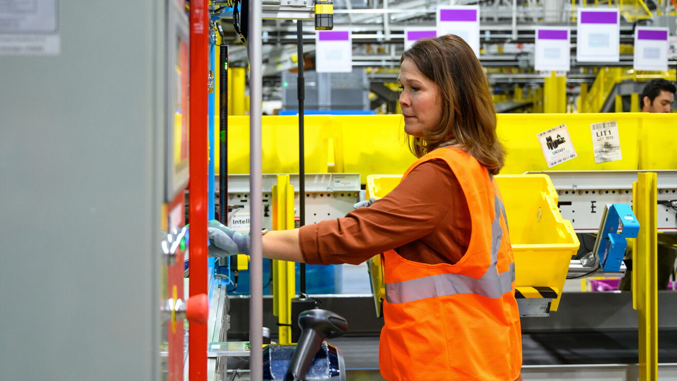 A photo of a fulfillment centre employee operating a machine.