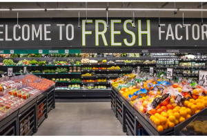 The fully stocked produce section of the new Factoria Amazon Fresh store. A sign above the produce reads, welcome to fresh Factoria.