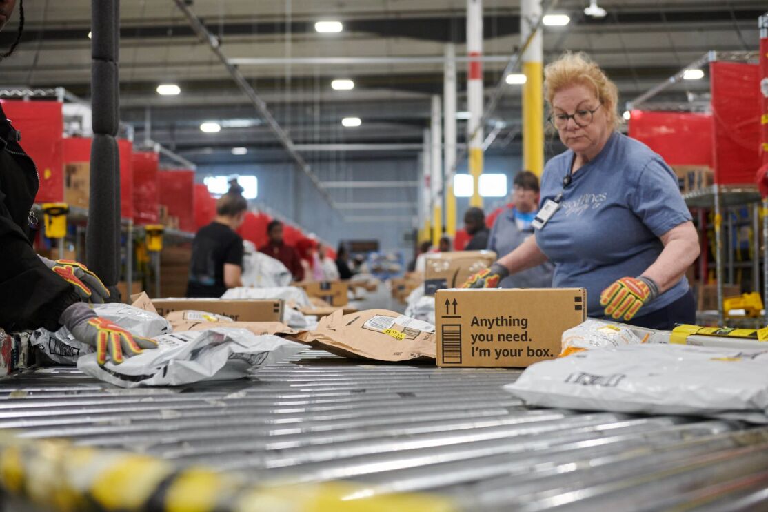 Amazon fulfillment center with employees processing orders