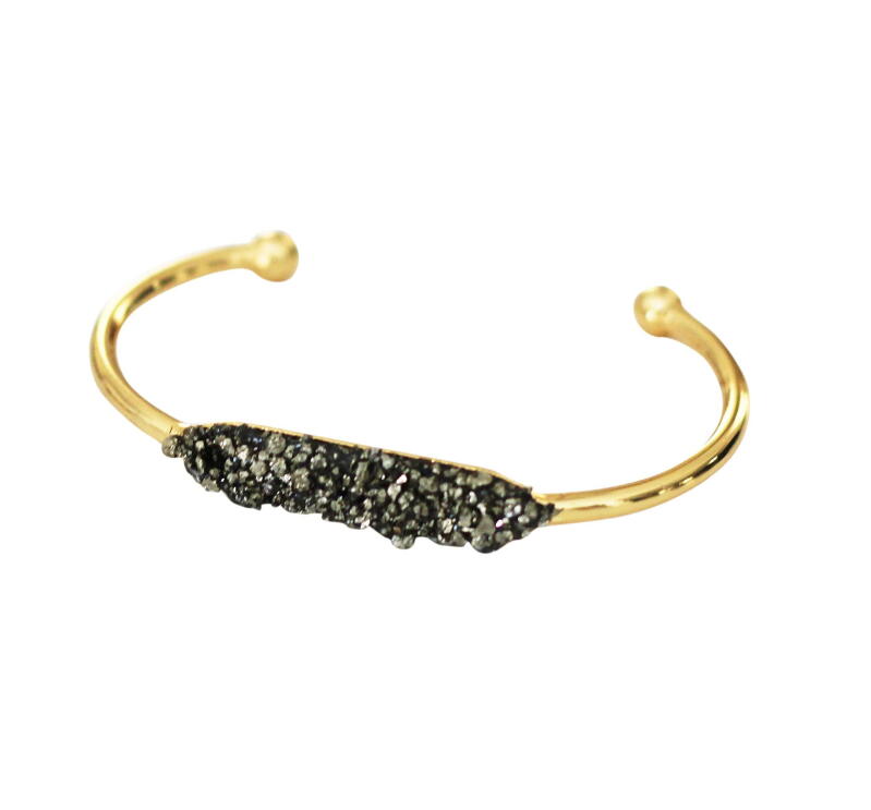 A flat shot of handmade jewelry with raw and semi-precious stones made by T. Victoria.