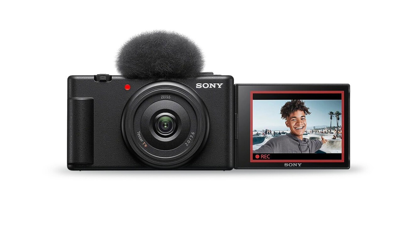 An image of a Sony camera with a fuzzy mic screen on top and an LED screen previewing the image.