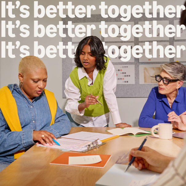 colleagues working together in a meeting room with the text "it's better together" overlayed on the graphic.