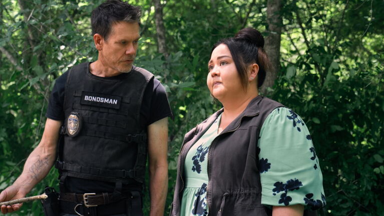 Kevin Bacon and Jolene Purdy (right) in the woods during a scene in 'The Bondsman.'