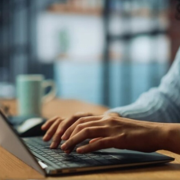 A person typing on a laptop
