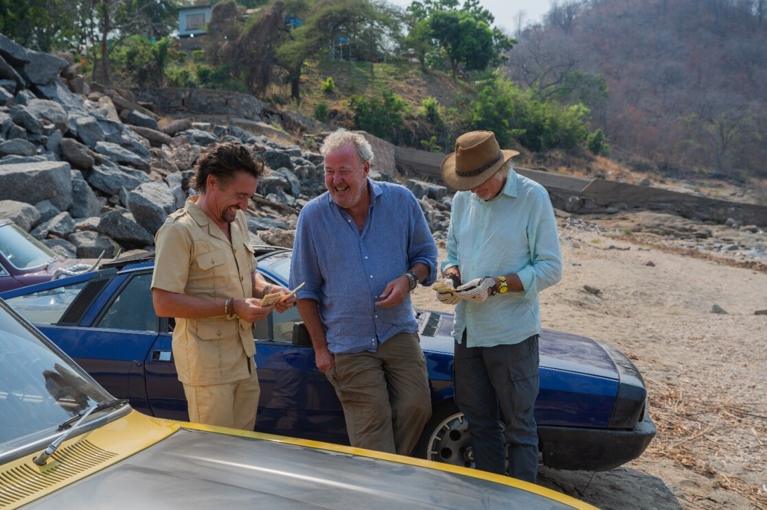 A screenshot from The Grand Tour featuring Richard Hammond, Jeremy Clarkson, and James May