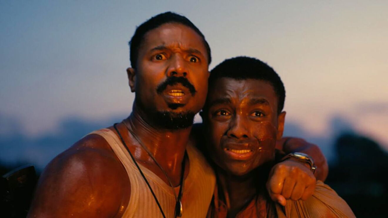 Two men stare into the distance