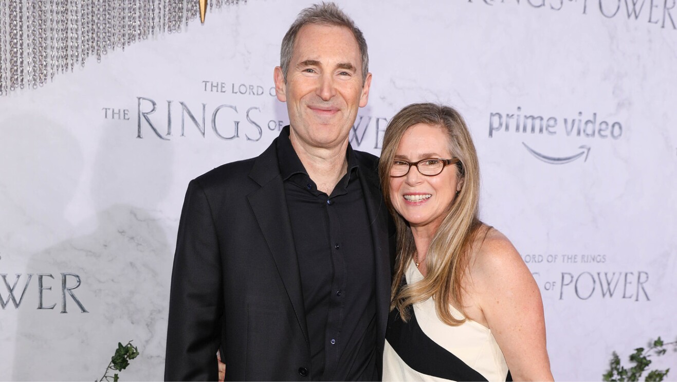 Andy Jassy and his wife smile for a photo on the red carpet of the Lord of the Rings the Rings of Power premiere