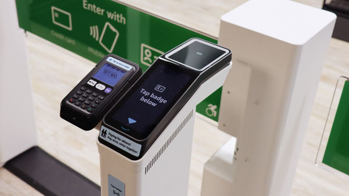 A photo of a scanner in front of a hospital retail store, powered by Just Walk Out technology, offering the option to tap a hospital employee badge for entry.