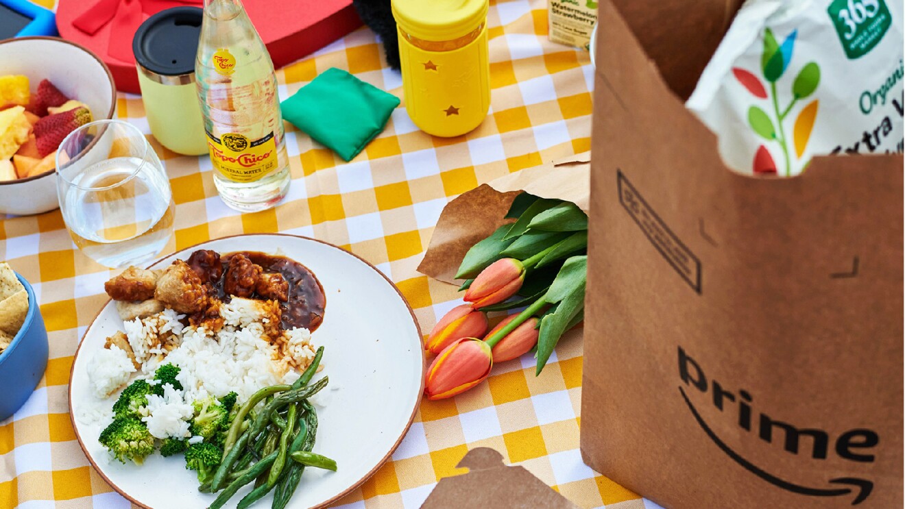 Prime Day 2023 live blog best deals: flowers, food, and a Prime bag on a yellow picnic blanket.
