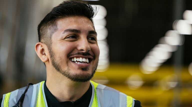 An image of Amazon employee Francisco Nino in a work vest at Amazon in Greenwood, Indiana.