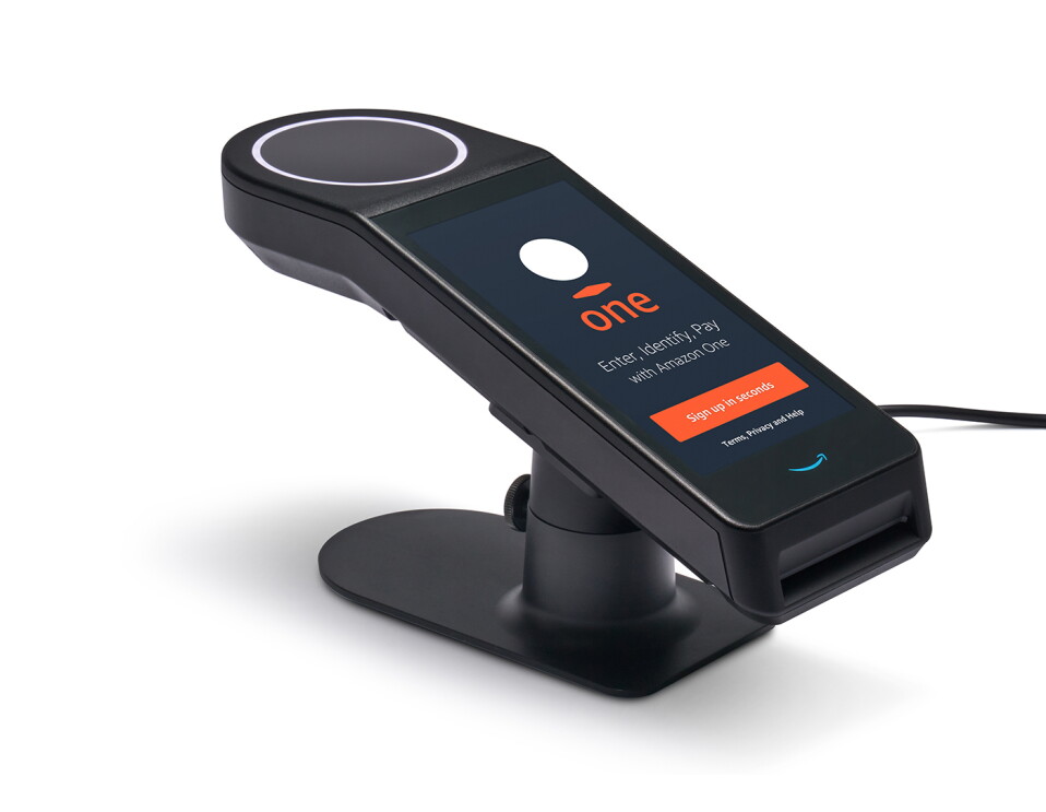 An Amazon One device. Text says "Enter, identify, pay with Amazon One. Sign up in seconds.