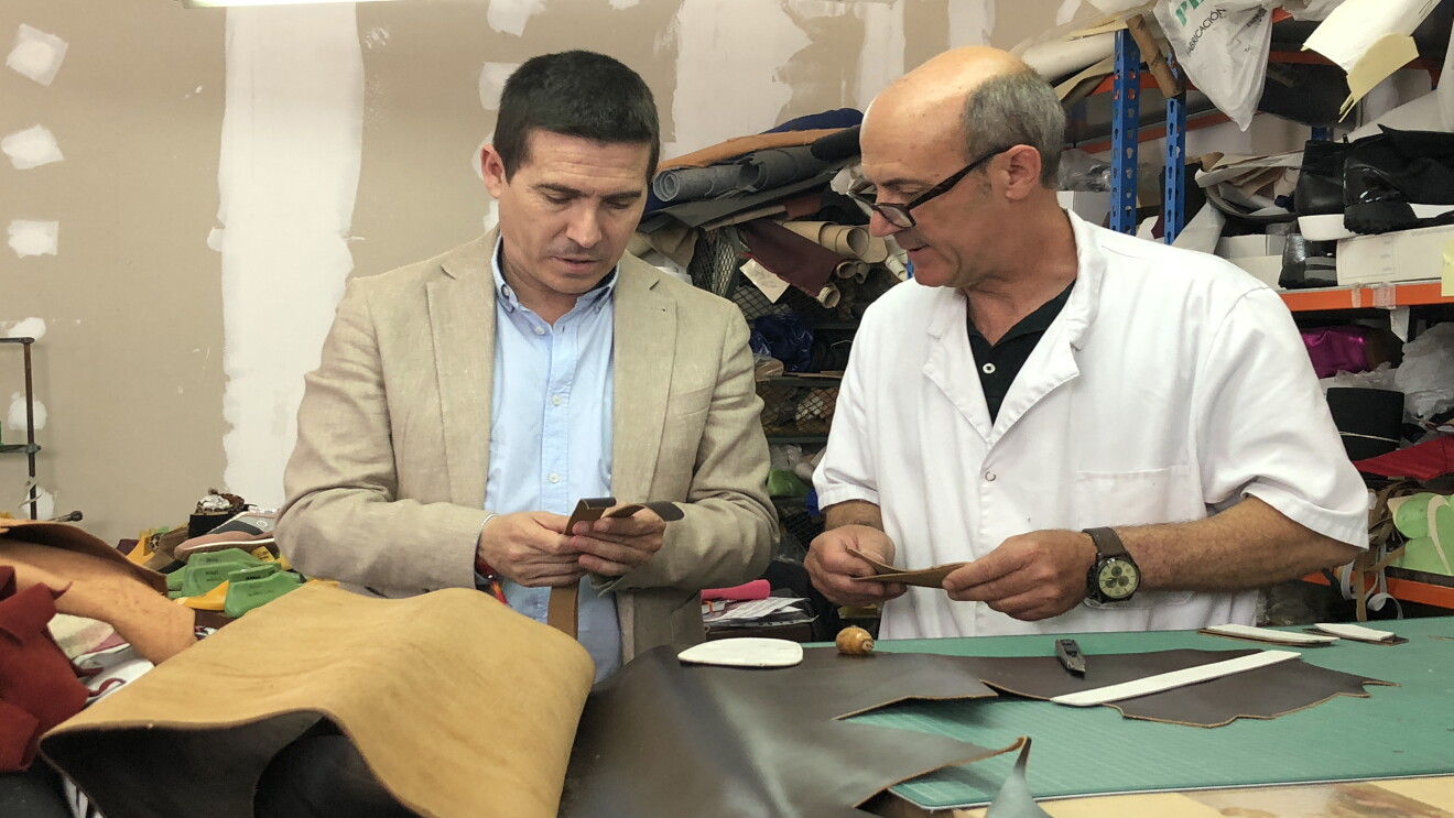 José Antonio Mollá, founder of Castellanisimos,  a Spanish shoemaker is working on leather choices with his employee in a room of leather samples for shoes. 