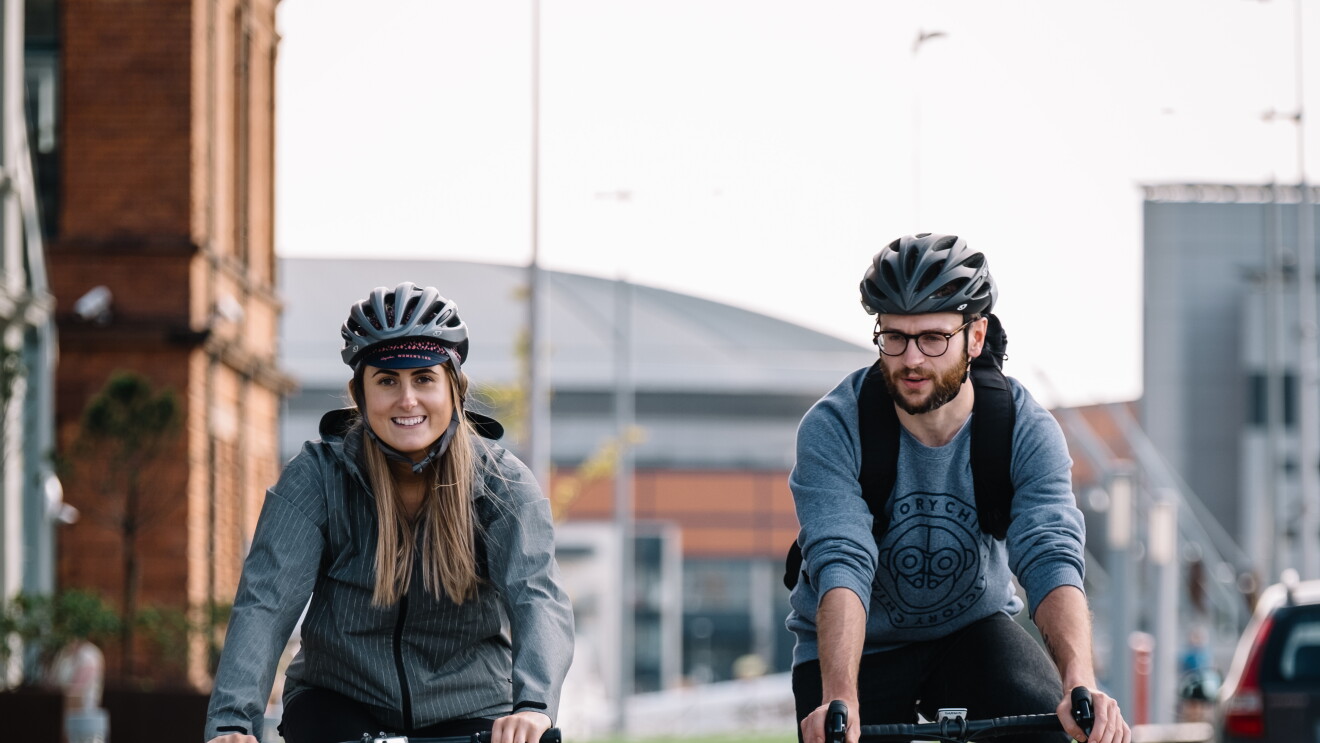 two cyclists riding in the city 
