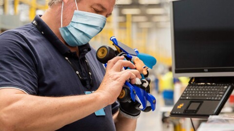 An Amazon employee prepares a toy to be resold or donated