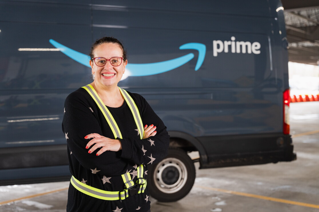 women standing in front of amazon truck 