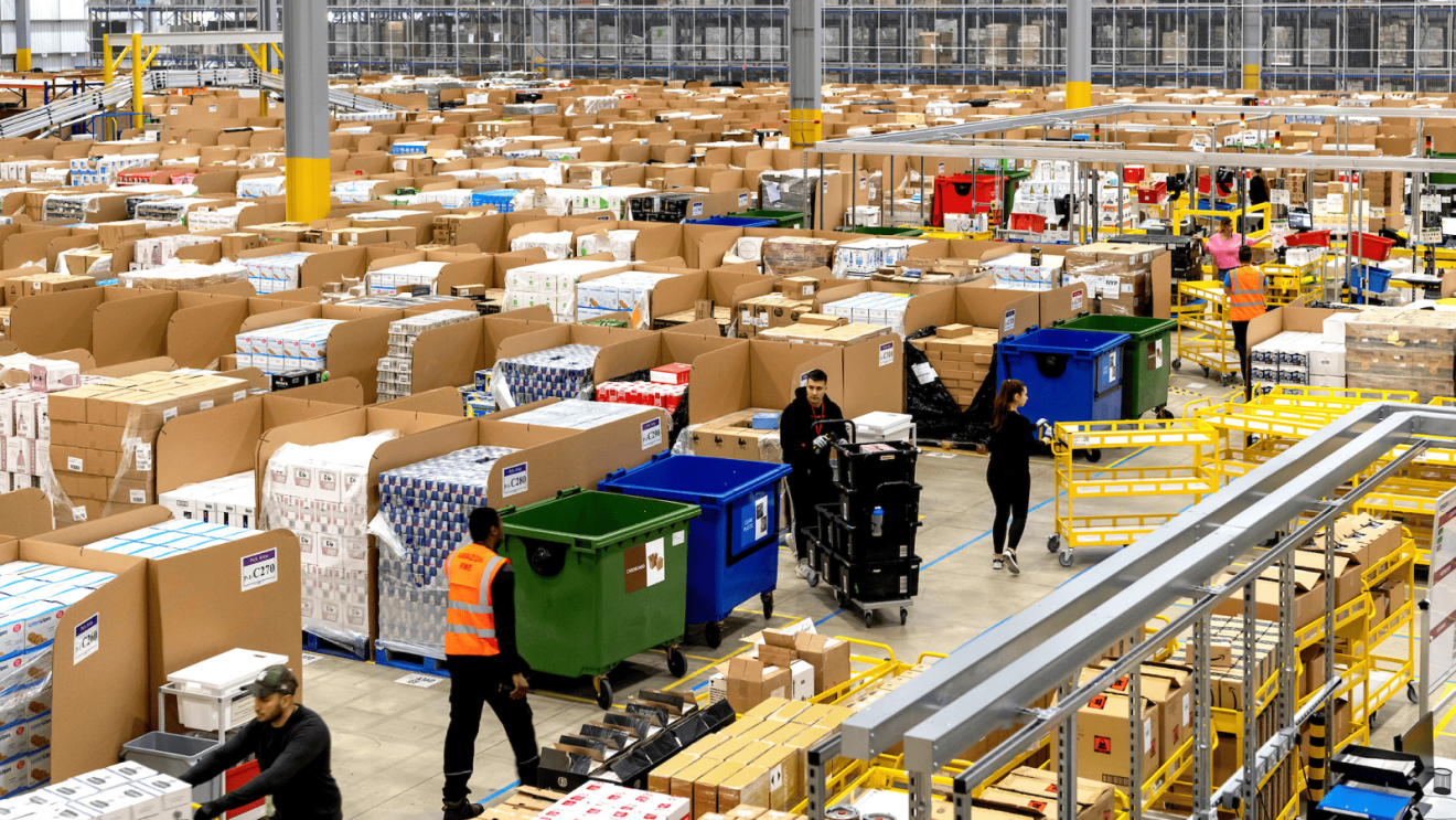 Massive warehouse with employees moving stock
