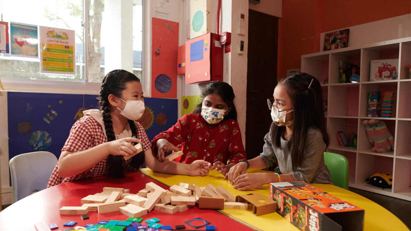 Three young children playing with toys that have been donated to NPOs as part of Amazon.sg's Delivering Smiles campaign