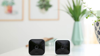 Two Blink indoor/outdoor cameras on a countertop.
