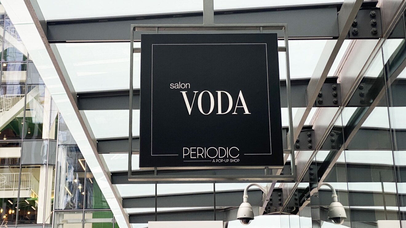 The sign for the "VODA" salon hangs above a storefront at Amazon's HQ.