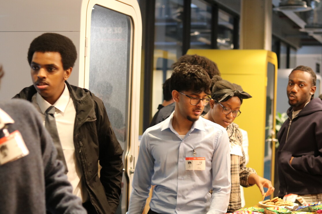 Young professionals and students gathered for a work experience project