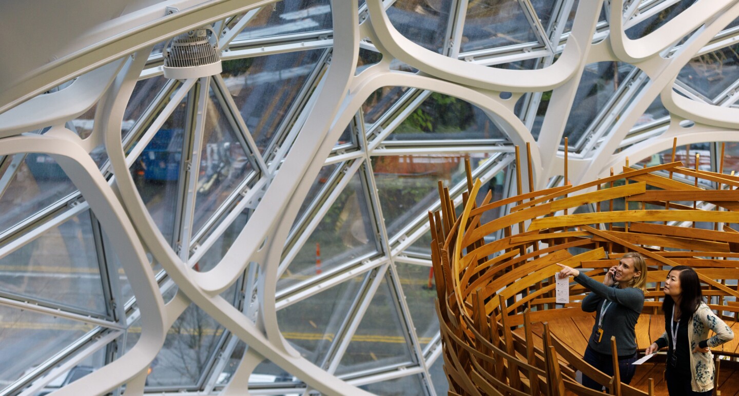 Two women stand in The Nest within the Amazon Spheres on opening day.