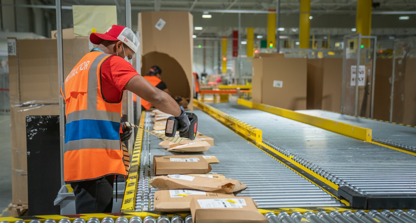 Photos of Amazon associates working in a Fulfillment Center in France.