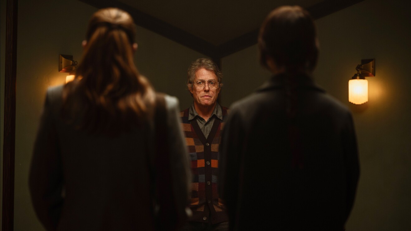 Tense confrontation in dimly lit hallway with three people