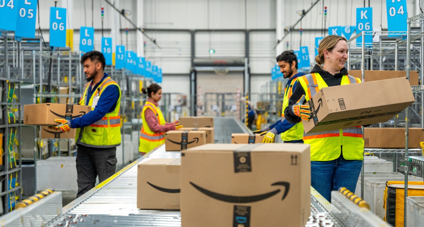 Employees moving boxes of conveyor
