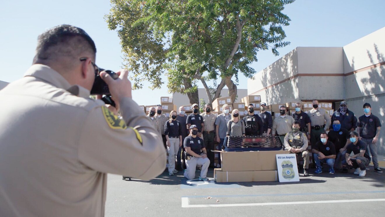 Police officers at the scene of where counterfeit items were found.