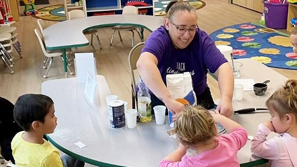 A photo of three children working with a teacher at a new childcare center in Pendleton, Oregon.