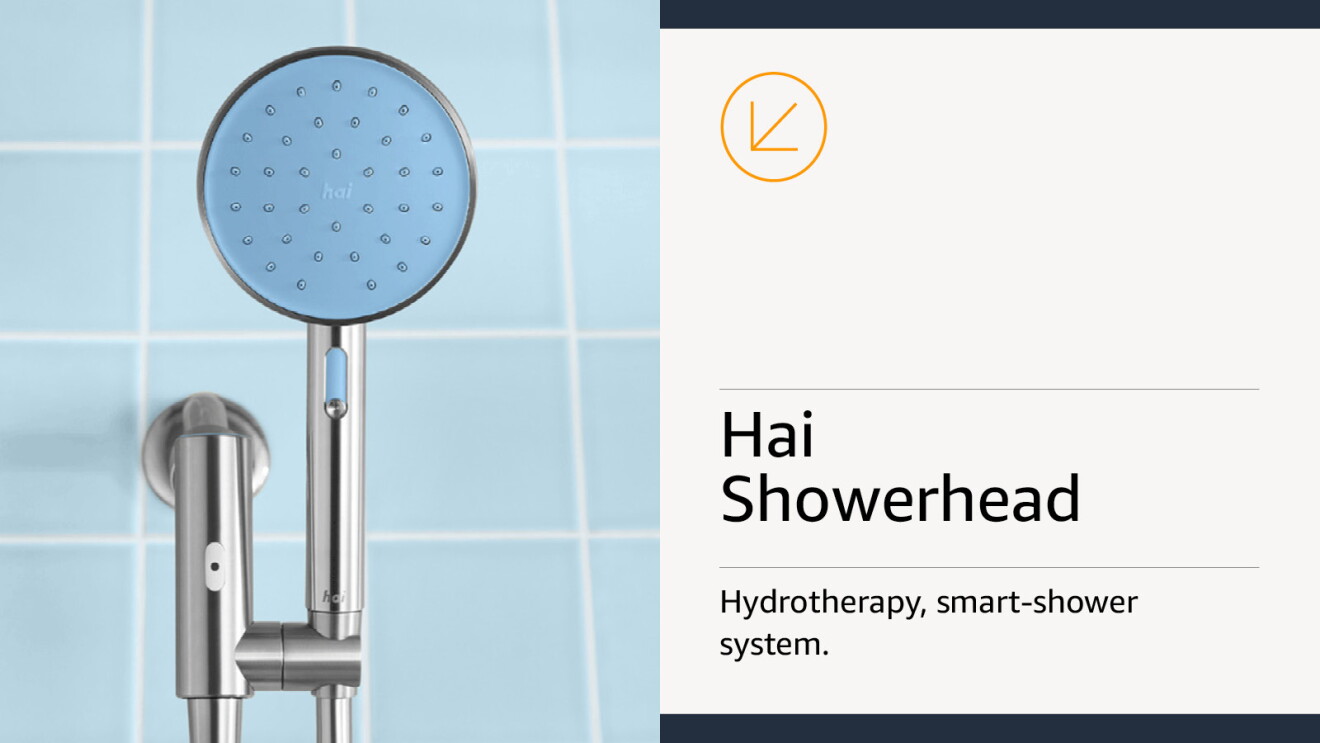 Stainless-steel showerhead attached to a tiled bathroom wall