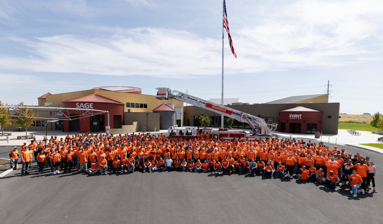 Hundreds of Amazon volunteers gather in front of the Sage Center in Umatilla, Oregon after a community cleanup event.