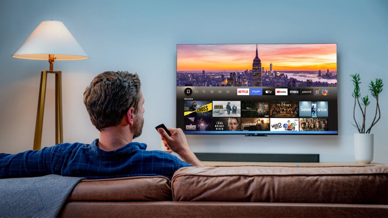 Person watching Fire TV displaying streaming apps and New York City skyline