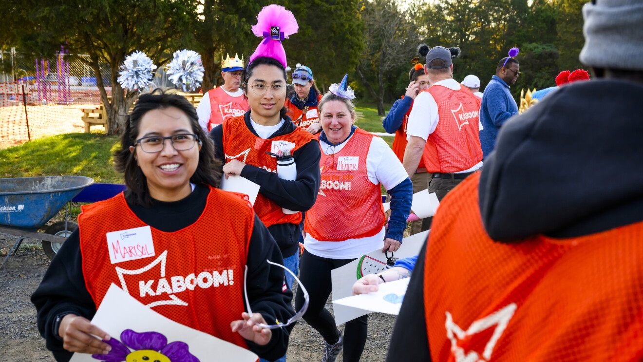 KABOOM! and AWS: Volunteers in bright orange Kaboom! vests gather outdoors for community event