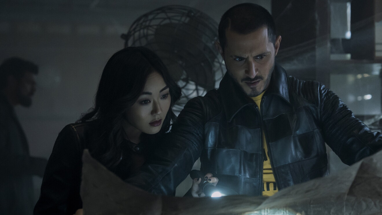The Boys: Two people examining something with a flashlight in a dark, industrial setting