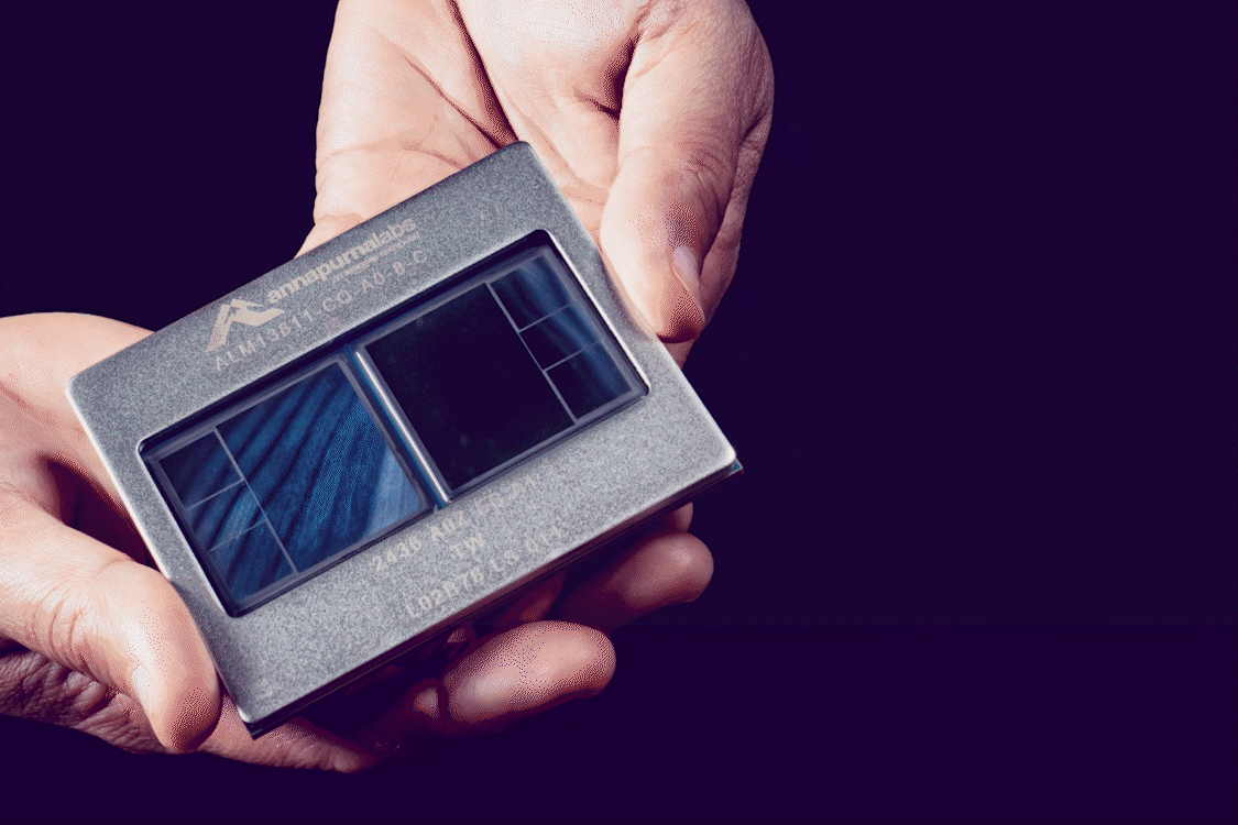 An AWS chip in the palm of a person's hands.