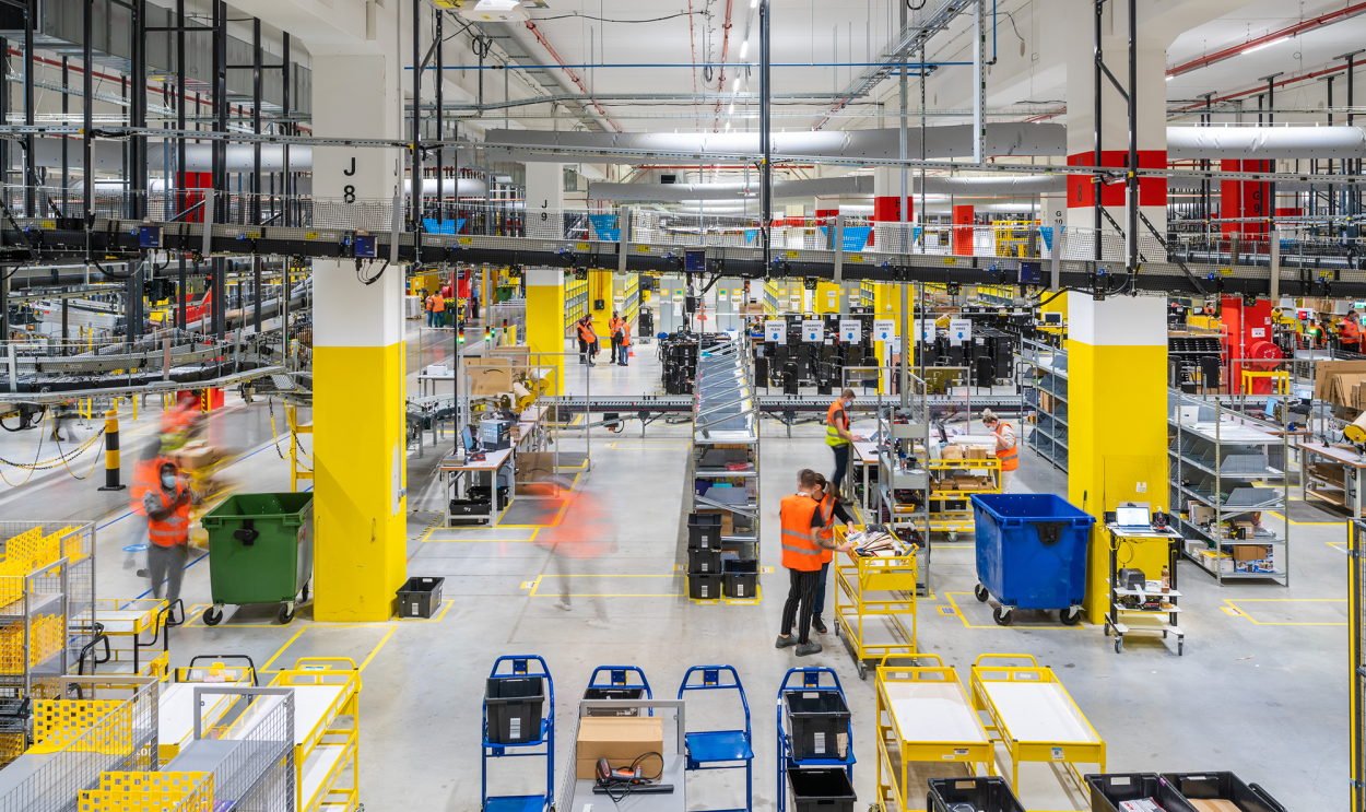 Intérieur d'un grand entrepôt avec des stations de tri et d'emballage colorées