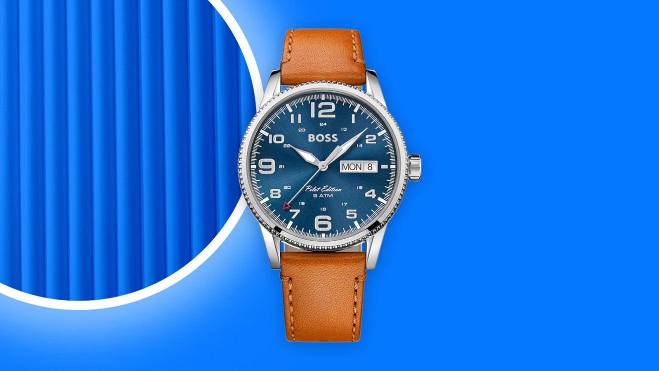 Boss wristwatch with blue dial and tan leather strap on vibrant blue background