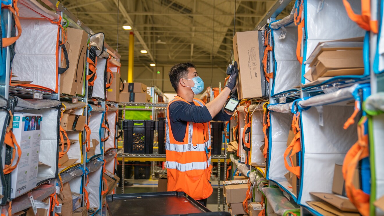 Photos of Amazon associates working in a Fulfillment Center in France.