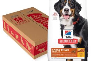 A bag of Hill's dog food next to a cardboard box decorated with silhouettes of dogs.