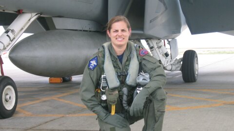 how to make a resume google docs An image of Sarah Rhoads in her pilot gear kneeling in front of a large plane and smiling for a photo.