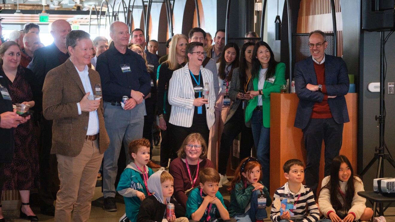 Large group gathered for conference or event, mix of adults and children