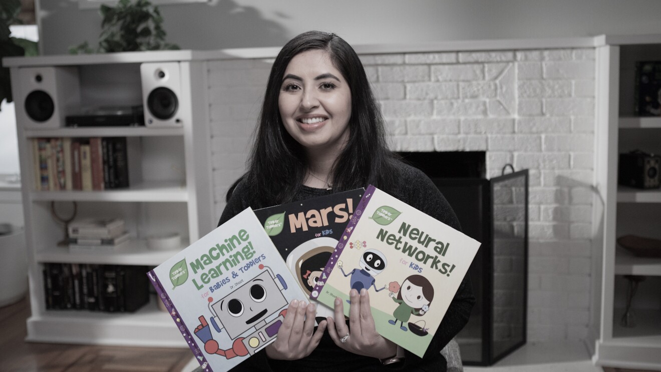 A woman holds three books for children that she self-published on KDP