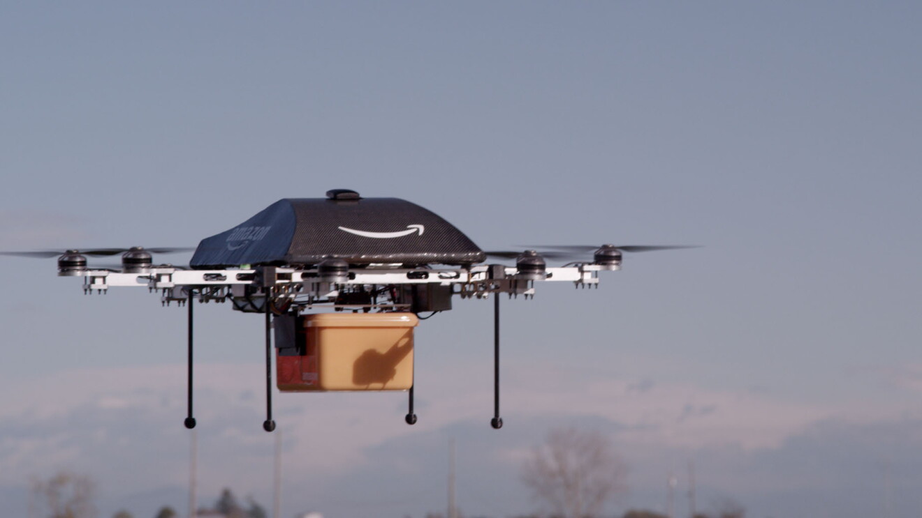 An Amazon Prime Air drone prototype in flight with a cargo container
