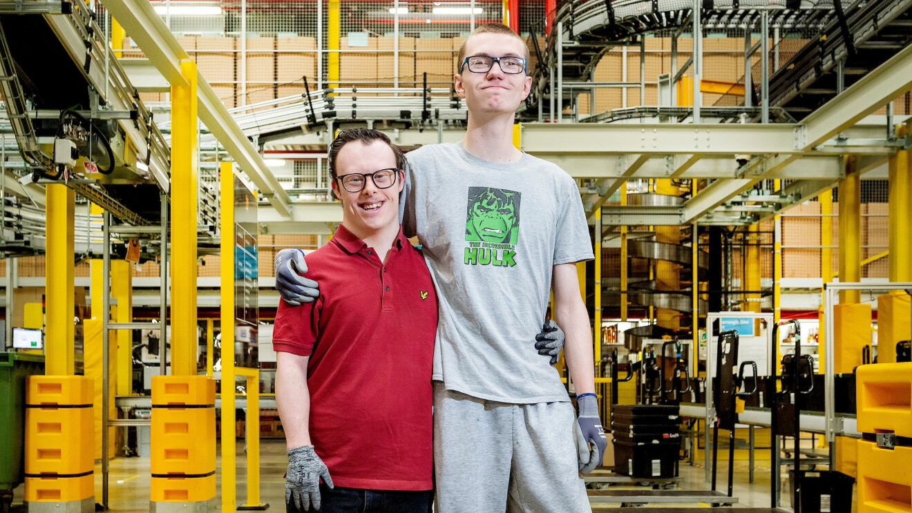 Jamie and Brandon stand together in the Rugby fulfilment centre