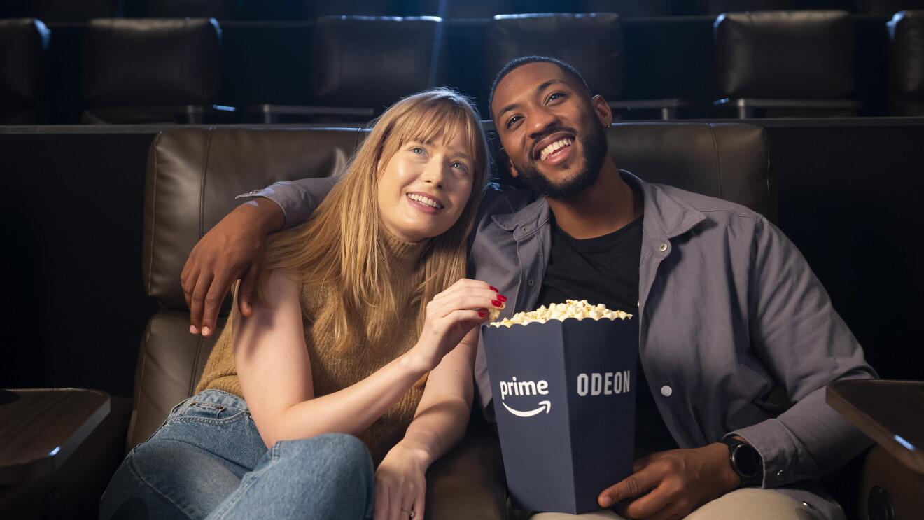 A woman and a man enjoy date night on Amazon Prime and Odeon