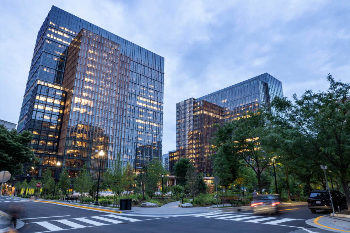 A photo of Amazon HQ2's two 22-story office buildings located at Metropolitan Park in Arlington, Virginia from street level.
