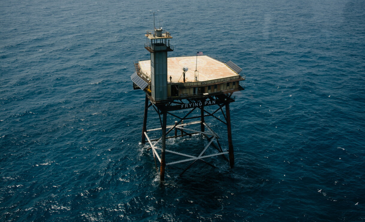 Frying Pan Tower surrounded by water.
