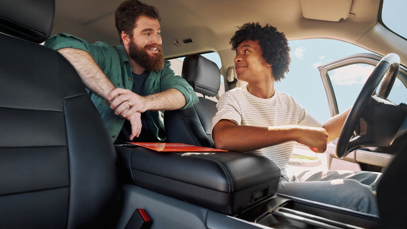 Father and Son inside a vehicle purchased via Amazon Autos