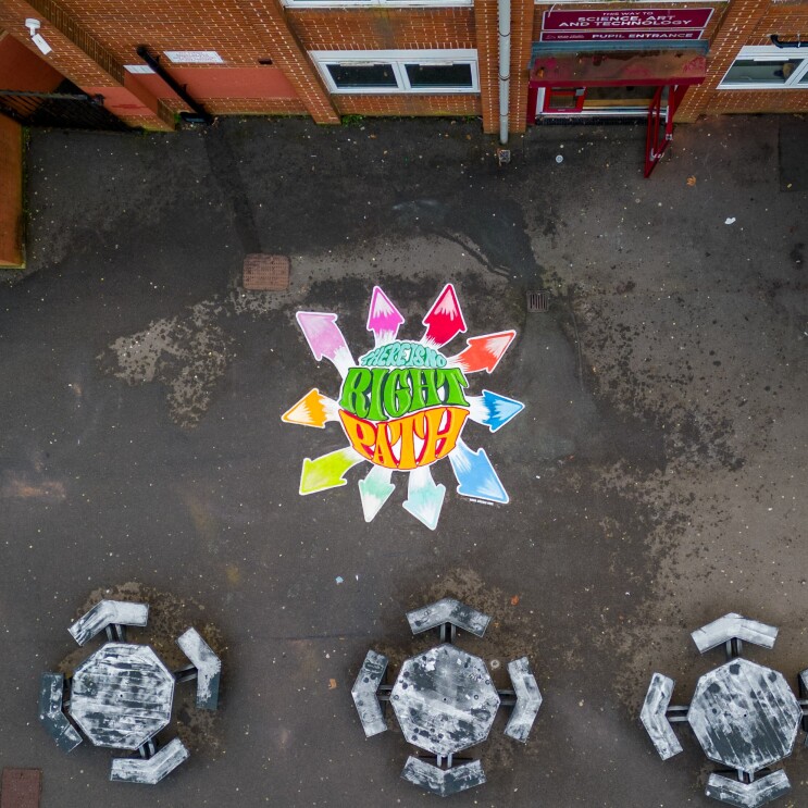 An overhead shot of a playground featuring a Sara Davies MBE quote